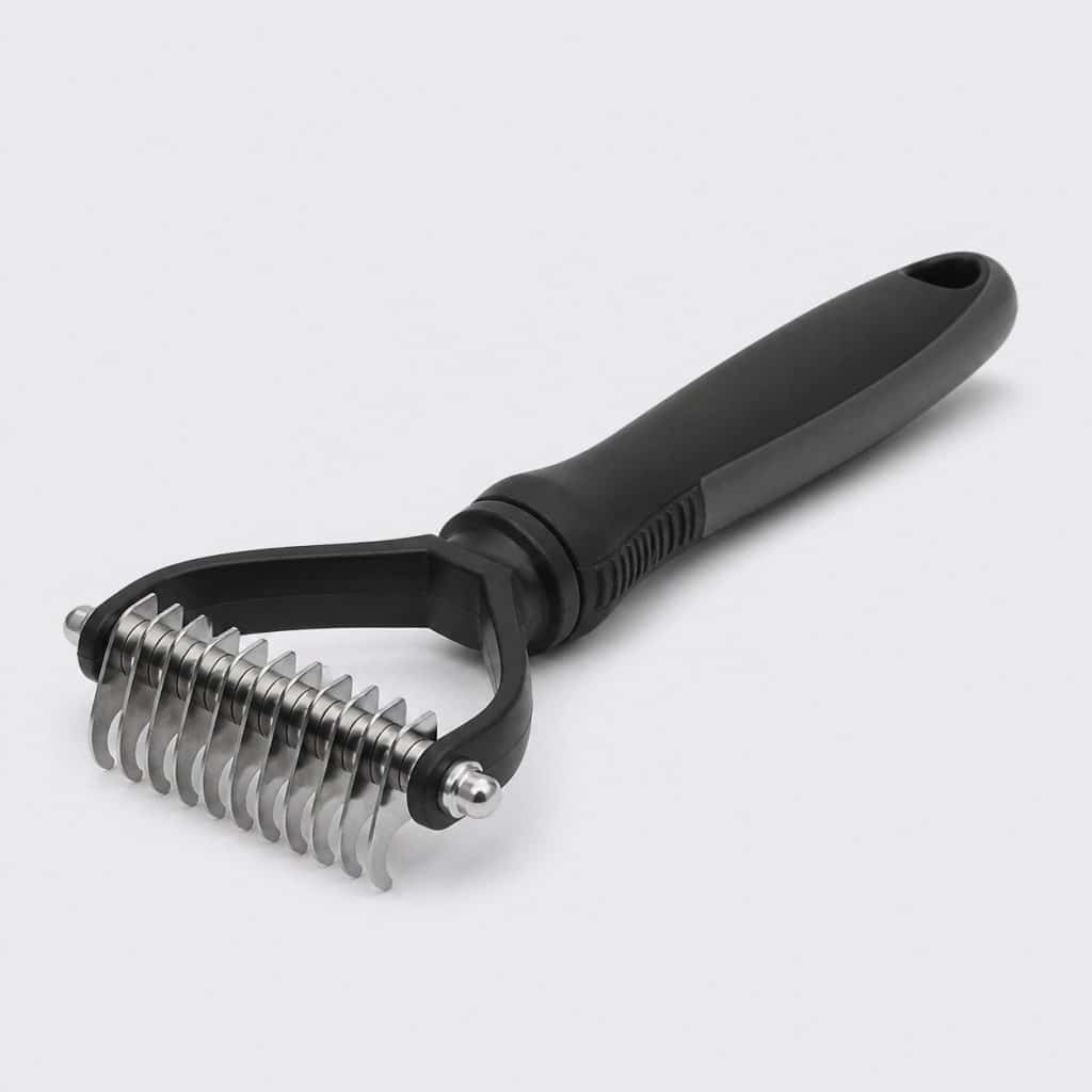 Brosse démêlante à dents rotatives en acier inoxydable pour chien