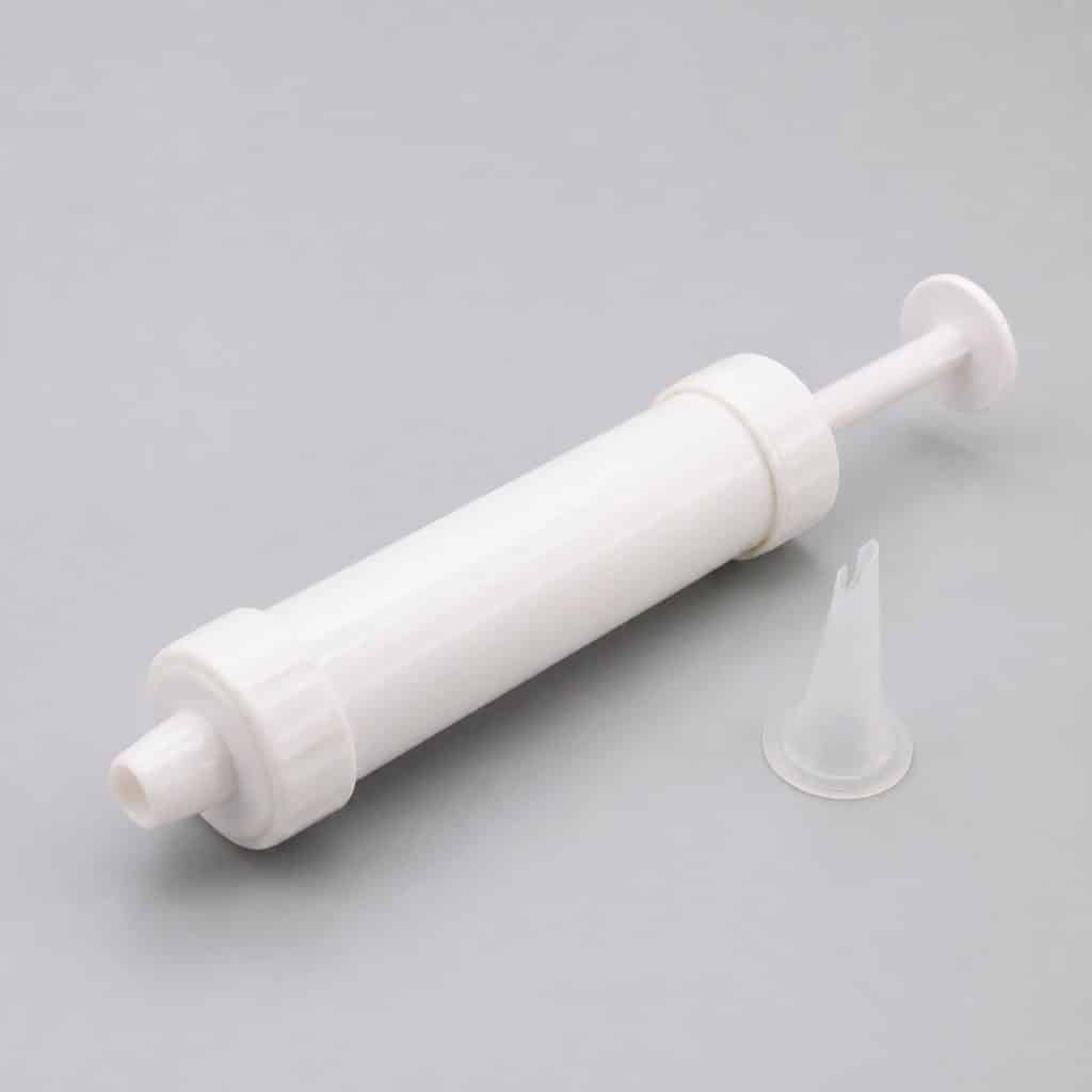 Lance-comprimés souple de 15,5 cm avec son embout silicone démonté